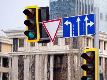 Close up view of an intersection street light and street signs